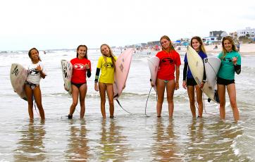 Surfers hit the water Saturday for the season’s first contest.