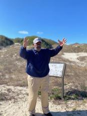 Ron Miller in front of “Nana” the largest dune in Florida. 