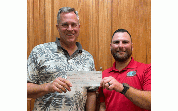 Mike Doran, chairman of the Veterans Council of Nassau County, left, and Fred Blaz, chairman of Veterans4VeteransNassau, proudly display a check from Rayonier. The money is earmarked for the Veterans4VeteransNassau gathering scheduled for April 22 at West Nassau High School in Callahan. Submitted photo