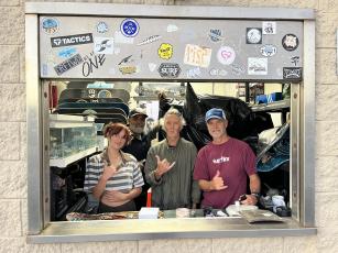 From left, Bella Peters, Wally Borrero, Ken Pinson and Mike Nichols look through the window of Dina’s Skate Shack. Photo by Sean Rosenthal/News-Leader