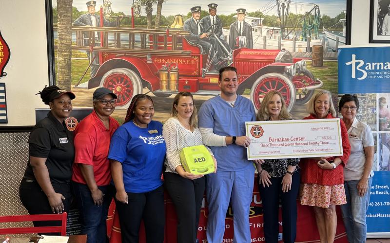 Pictured are, from left, Firehouse Subs Fernandina Beach General Manager Erica Melton, Firehouse Subs District Manager Katie Lott, Barnabas Community Health worker Quashana Levy, Barnabas nurse practicioner Megan Cagle, Barnabas front office manager and EMT Kevin Sharkey, Barnabas Health Services manager Michele VandenBossche, Barnabas President and CEO Jamie Reynolds and Firehouse Subs Catering and Special Events manager Cindi Ross. Photo by Sean Rosenthal